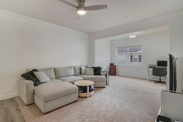 living room featuring ceiling fan, ornamental molding, and wood-type flooring