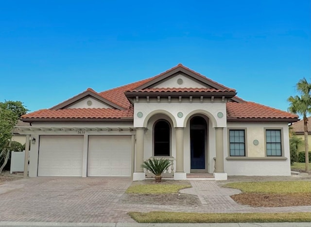 mediterranean / spanish-style house with a garage