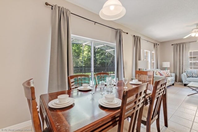 dining space featuring light tile patterned floors and ceiling fan