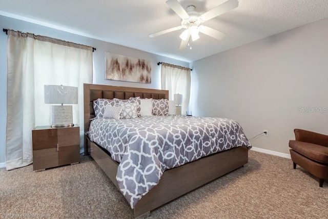 carpeted bedroom with a textured ceiling and ceiling fan