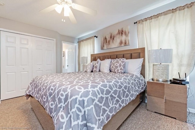 bedroom featuring ceiling fan, light colored carpet, and a closet