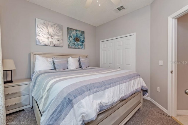 bedroom featuring ceiling fan, carpet, and a closet