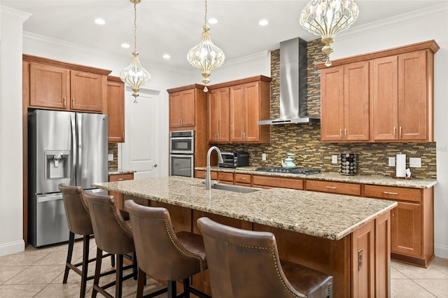 kitchen with stainless steel appliances, wall chimney range hood, a sink, and crown molding