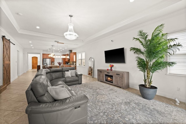 living room with light tile patterned floors, an inviting chandelier, a healthy amount of sunlight, and a barn door