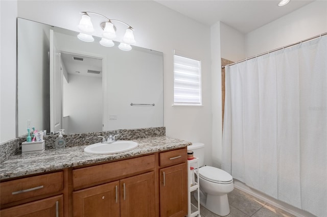 bathroom with toilet, tile patterned flooring, and vanity