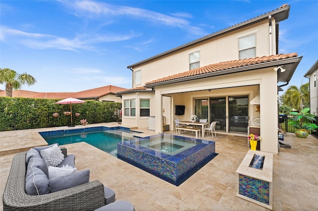 view of pool with outdoor lounge area, an in ground hot tub, and a patio