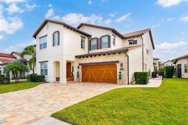 mediterranean / spanish home with a garage, stone siding, decorative driveway, stucco siding, and a front lawn