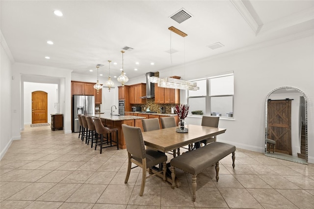 dining area featuring visible vents, crown molding, baseboards, and light tile patterned floors