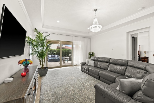 living room featuring a chandelier, a raised ceiling, and crown molding