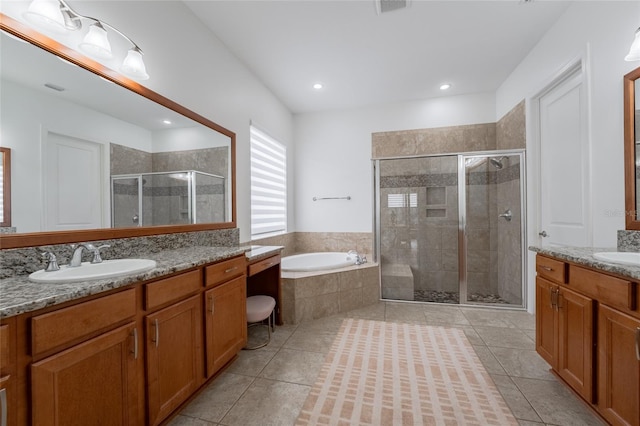 full bathroom with a garden tub, tile patterned flooring, two vanities, a sink, and a stall shower