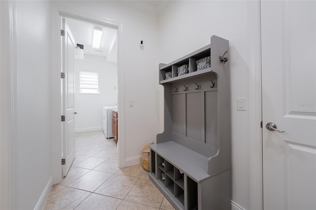 mudroom featuring baseboards and light tile patterned flooring