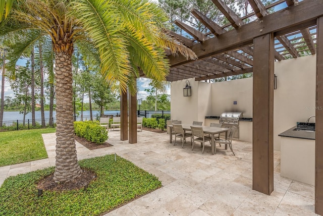 view of patio / terrace featuring an outdoor kitchen, area for grilling, fence, outdoor dining area, and a pergola