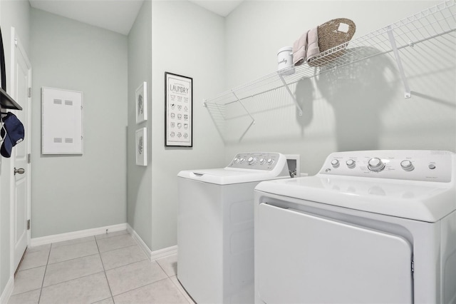 laundry area with washing machine and dryer and light tile patterned flooring