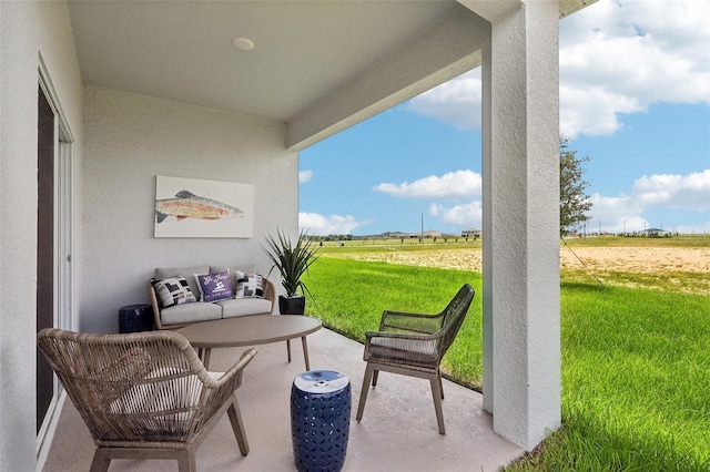 view of patio / terrace featuring a rural view and an outdoor living space