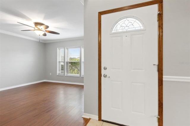 entryway featuring crown molding, wood-type flooring, and ceiling fan