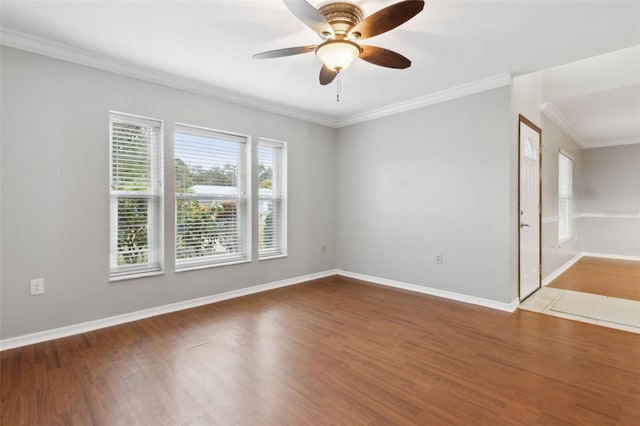 spare room featuring wood-type flooring, ornamental molding, and ceiling fan