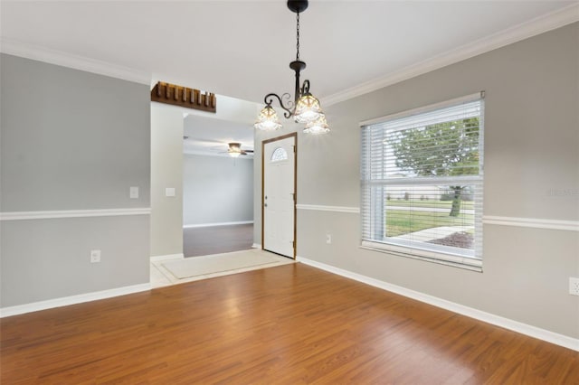 spare room with wood-type flooring, ornamental molding, and ceiling fan