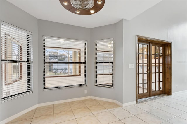 tiled empty room with french doors