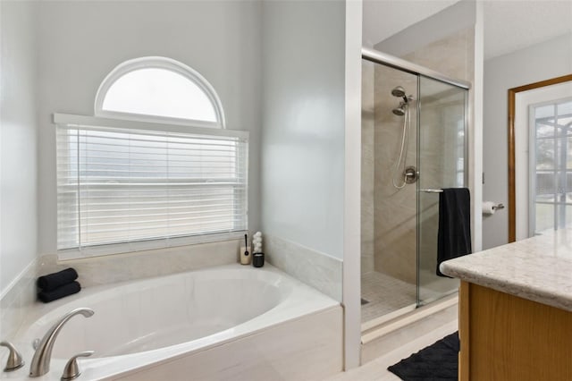 bathroom featuring plus walk in shower and vanity