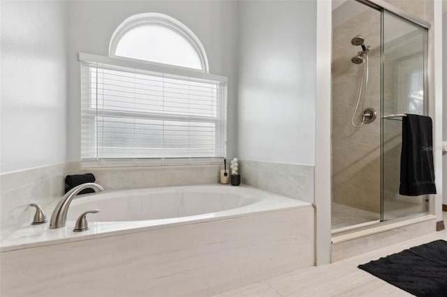 bathroom featuring tile patterned flooring and independent shower and bath