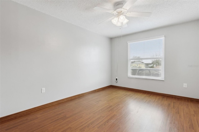 spare room featuring hardwood / wood-style floors, a textured ceiling, and ceiling fan