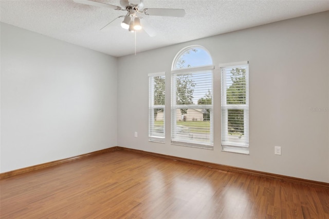 unfurnished room featuring hardwood / wood-style floors, a textured ceiling, and ceiling fan