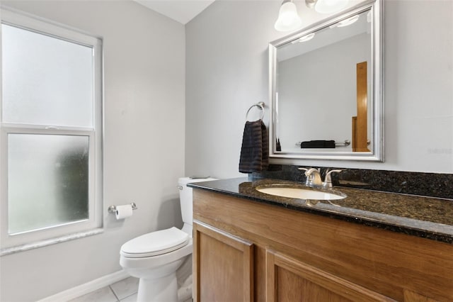 bathroom with vanity, tile patterned floors, and toilet