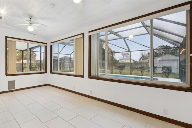 spare room with vaulted ceiling, light tile patterned floors, and ceiling fan