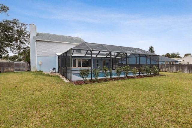 view of pool featuring a lanai and a lawn