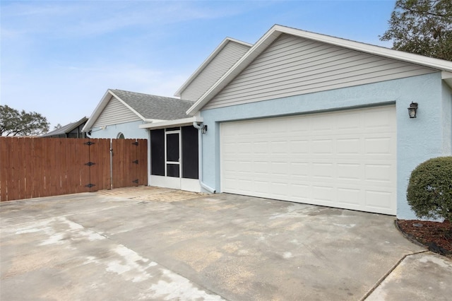 view of front of home featuring a garage and a sunroom