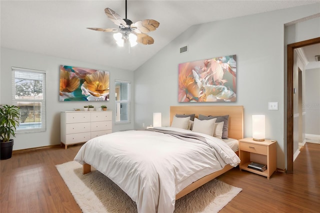 bedroom with ceiling fan, wood-type flooring, and lofted ceiling