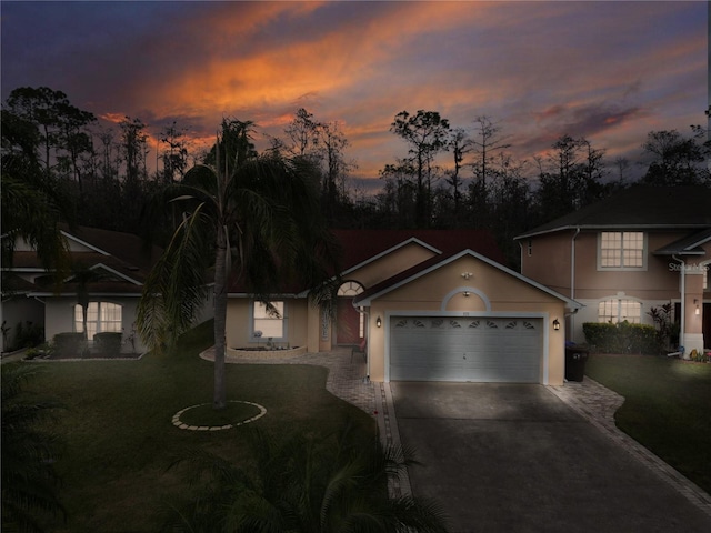 view of front of home featuring a lawn and a garage