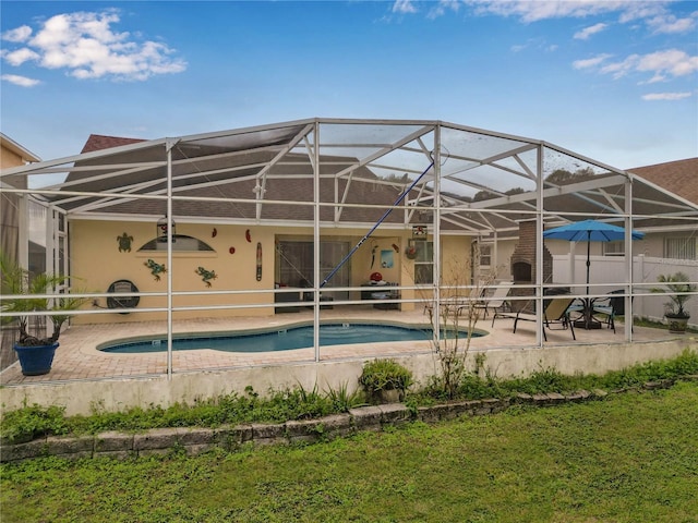 view of swimming pool featuring a lanai and a patio