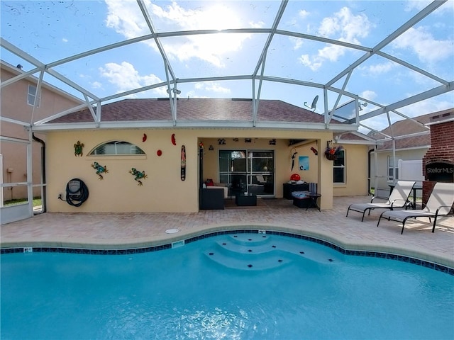 back of property featuring a lanai and a patio