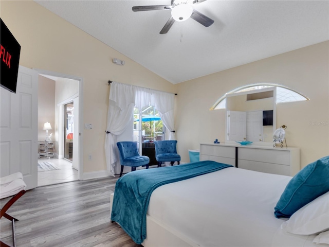 bedroom with lofted ceiling, ceiling fan, and light hardwood / wood-style floors