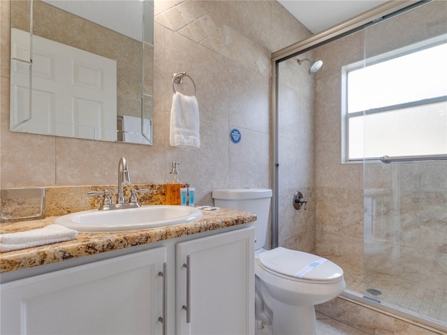 bathroom with toilet, decorative backsplash, tile walls, a shower with door, and vanity