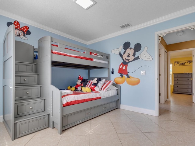 bedroom with a textured ceiling, light tile patterned flooring, and ornamental molding