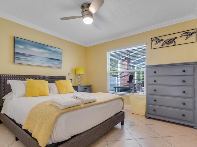 tiled bedroom with a textured ceiling, ceiling fan, and ornamental molding