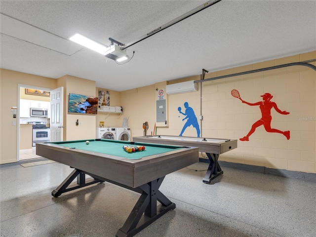 game room featuring an AC wall unit, pool table, electric panel, a textured ceiling, and washing machine and clothes dryer