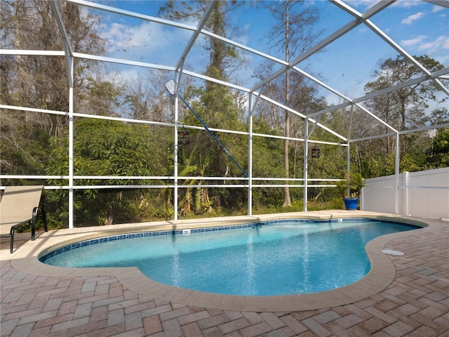 view of swimming pool with a lanai and a patio