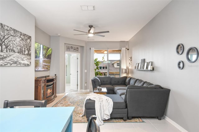 living room featuring ceiling fan and light tile patterned floors