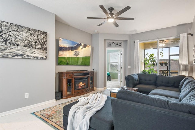 living room featuring tile patterned floors, a fireplace, and ceiling fan