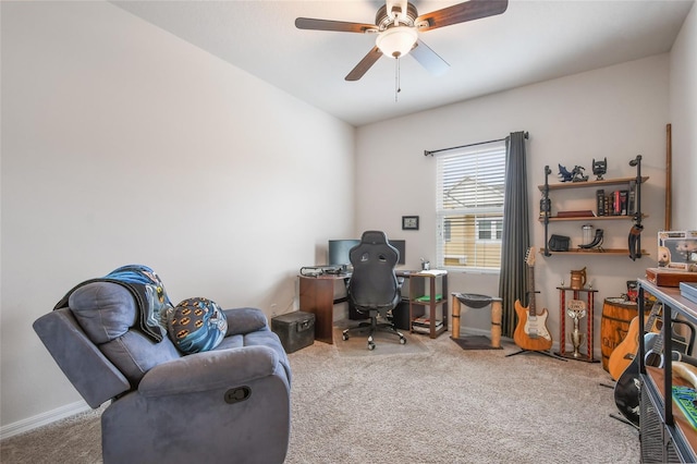 carpeted office featuring ceiling fan