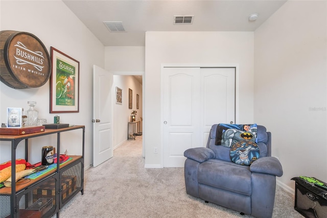 living area featuring light carpet