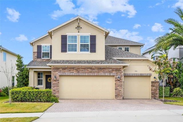1416 Cabot Dr, Clermont, FL 34711 - view of front of property with stucco siding, decorative driveway, a shingled roof, and stone siding