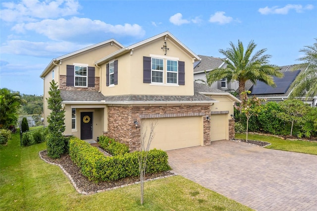 1416 Cabot Dr, Clermont, FL 34711 - view of front facade featuring decorative driveway, a front lawn, stone siding, and stucco siding