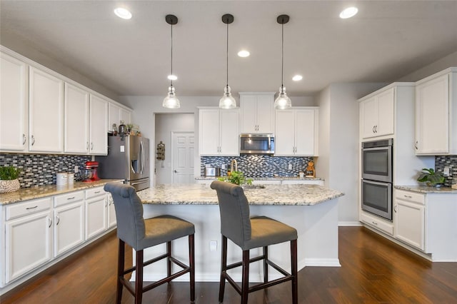 1416 Cabot Dr, Clermont, FL 34711 - kitchen featuring tasteful backsplash, recessed lighting, a kitchen island with sink, stainless steel appliances, and white cabinets