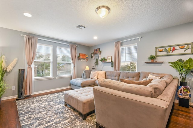 1416 Cabot Dr, Clermont, FL 34711 - living room with a textured ceiling, visible vents, dark wood-style floors, and baseboards