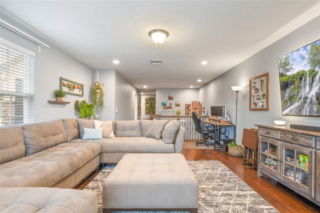 1416 Cabot Dr, Clermont, FL 34711 - living room featuring dark wood-type flooring, visible vents, recessed lighting, and a textured ceiling