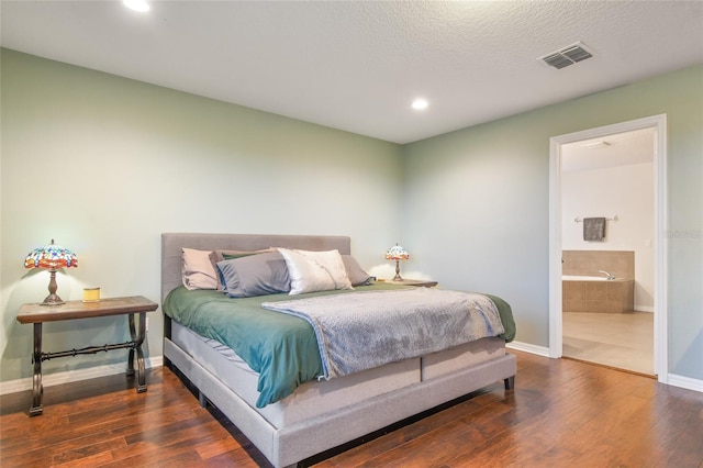 1416 Cabot Dr, Clermont, FL 34711 - bedroom featuring recessed lighting, connected bathroom, hardwood / wood-style floors, baseboards, and visible vents